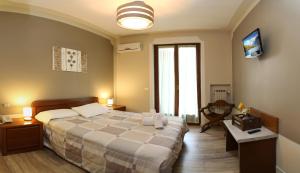 Ένα ή περισσότερα κρεβάτια σε δωμάτιο στο Hotel Andreis