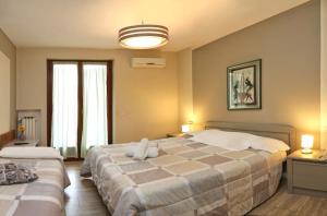 Ένα ή περισσότερα κρεβάτια σε δωμάτιο στο Hotel Andreis