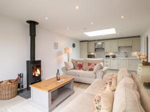 a living room with a couch and a fireplace at Fox's Den in Fareham