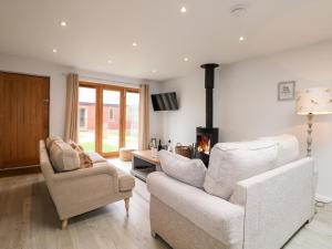 a living room with two chairs and a fireplace at Fox's Den in Fareham
