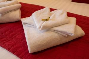 a pile of towels with a ring on top of them at Il Piccolo Piacenza in Piacenza