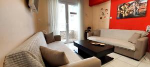 a living room with a couch and a table at Apollo 2 - Luxury Apartment in Katerini