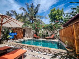 a swimming pool in a backyard with a table and chairs at Ekas Surf Resort & Surf Camp in Ekas
