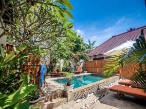 a swimming pool in the backyard of a house at Ekas Surf & Kitesurfing Resort in Ekas