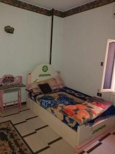 a bedroom with a bed with a laptop on it at الفاوى - القصير in Quseir