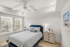 a white bedroom with a bed and a window at The Eagles Nest in Rosemary Beach +48 photos
