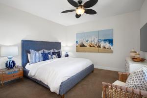 a bedroom with a bed and a ceiling fan at Pili Mai 6K in Koloa +25 photos