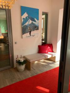 a room with a bench and a painting on the wall at Bergland Hotel - Adults only in Salzburg