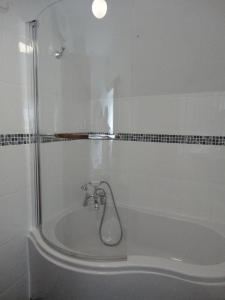 a bathroom with a bath tub with a shower at The Cottage in Moretonhampstead