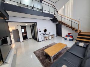 a living room with a couch and a table at Yeosu Thestay Hostel in Yeosu