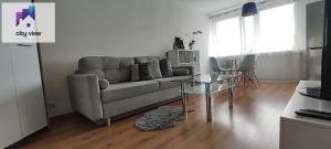 a living room with a couch and a glass table at CITY VIEW Zamenhofa in Świdnica