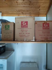 three boxes sitting on top of a shelf at Le chalet de Sabine et Patrick in Vicdessos