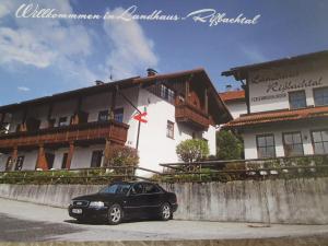 a black car parked in front of a building at Landhaus Rißbachtal in Bodenmais