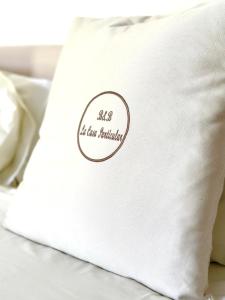a white pillow sitting on top of a bed at La Casa Particular in Bari