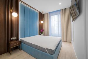 グダニスクにあるApartament Amber centrumの青い壁のベッドルーム1室(ベッド1台付)