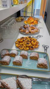 a buffet of pastries and breads on a table at Sea Garden Peniche in Peniche