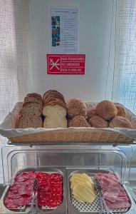 a display case with a tray of pastries and bread at Sea Garden Peniche in Peniche