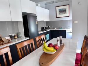 a bowl of fruit on a table in a kitchen at Arthurton Central in Hobart