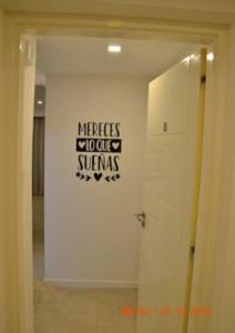 a room with a white door and a sign on the wall at TERAPIA DIVINA in Saladillo