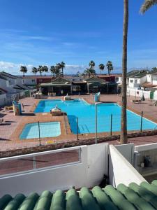 a view of a swimming pool in a resort at Entire townhouse in the paradise in Maspalomas