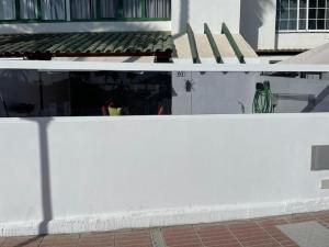 a white wall in front of a building at Entire townhouse in the paradise in Maspalomas