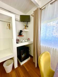 a living room with a fireplace and a yellow chair at La Casa Particular in Bari