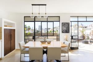 a dining room with a table and chairs at Amazing Duplex with 2 Terraces in City Center by FeelHome in Tel Aviv