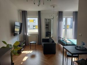 a living room with a couch and a table at Apartament Poziomkowa in Przasnysz