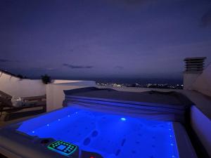 a hot tub with a remote control on top of a house at Bayview - Unique Top modern duplex penthouse with sea views and a private hot tub by Solrentspain in Benalmádena