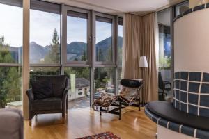 a living room with a view of mountains at Aparthotel Tritscher in Schladming