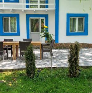 a table and chairs in front of a house at Pescarul Deltei in Murighiol