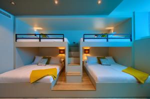 2 stapelbedden in een kamer met blauwe verlichting bij Luxury Villas LORD and LADY in Pinezici