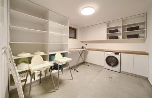 a laundry room with white cabinets and a washer and dryer at Luxury Villas LORD and LADY in Pinezici