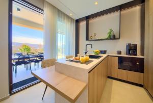 a kitchen with a counter and a table with oranges on it at Luxury Villas LORD and LADY in Pinezici