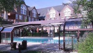 een zwembad voor een gebouw bij Domaine de la Forêt d'Orient, Logis Hôtel, Restaurant, Spa et Golf in Rouilly-Sacey