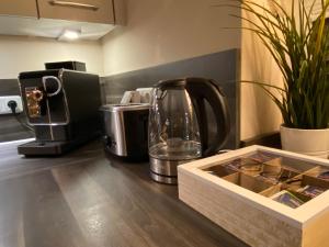 a kitchen counter with a coffee maker and a tea kettle at Villa Major in Göhren-Lebbin