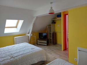 a bedroom with a bed and a tv in it at le four à pain in Faverolles