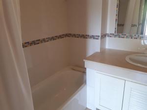 a bathroom with a bath tub and a sink at 1-Bed - Sleeps 4 - Free Parking & Balcony in Albufeira +20 photos