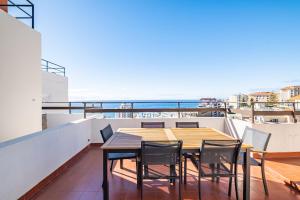 d'une table et de chaises sur un balcon avec vue sur l'océan. dans l'établissement Apartamento Casa Branca 360, à Funchal