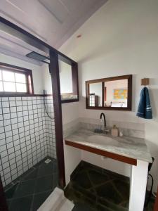 a bathroom with a sink and a mirror at Casa Sal in Paraty