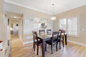 a dining room and kitchen with a table and chairs at The Gem of Palm Desert in Palm Desert