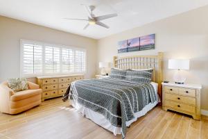 a bedroom with a bed and a ceiling fan at The Gem of Palm Desert in Palm Desert