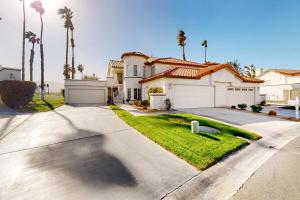 a house with palm trees and a driveway at The Gem of Palm Desert in Palm Desert