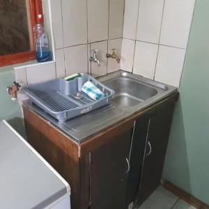 a kitchen sink with a tray on top of it at Fishermen s Cave in Port St. Johns +25 photos