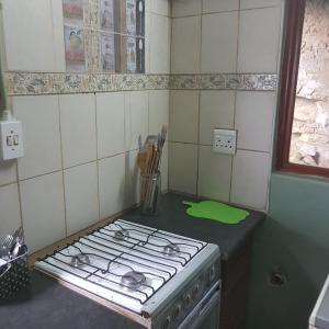 a kitchen with a stove top oven in a kitchen at Fishermen s Cave in Port St Johns