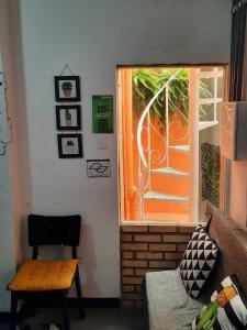 a room with a window and a table and a chair at Vilarejo Hostel Pinheiros Guest House in Sao Paulo