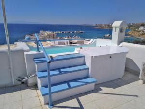 a set of blue stairs on the side of a building at Villa Danae - Seaside Villa with Pool & Hot Tub in Piso Livadi