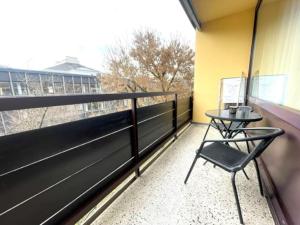 a balcony with a table and a chair on it at **Modernes Apartment in zentraler Lage** in Graz
