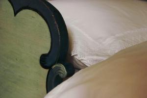 a close up of a bed frame with a pillow at Hirschen Stammheim in Oberstammheim