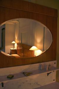 a bathroom with a large mirror over a sink at Hirschen Stammheim in Oberstammheim